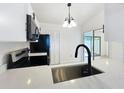Well-lit kitchen with stainless steel sink, appliances, and modern countertops at 6508 Coral Cove Dr, Orlando, FL 32818