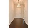 Inviting entryway with wood floors, a stylish light fixture, and a view into the home at 8742 Peachtree Park Ct, Windermere, FL 34786