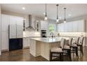 Bright kitchen featuring a large island, modern appliances, and white cabinetry at 1005 Talon Pl, Winter Springs, FL 32708