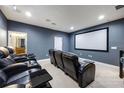 Home theater with comfortable seating, a large screen, and dim lighting for an immersive experience at 1005 Talon Pl, Winter Springs, FL 32708