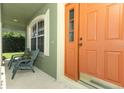 Inviting front porch with seating next to the front door at 1101 N Division St, Oviedo, FL 32765