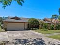 Charming home featuring a stone accent garage, well maintained lawn, and mature trees at 1139 Fairway Dr, Winter Park, FL 32792