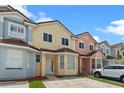 Charming townhomes with colorful facades, brown tile roofs, and well-maintained landscaping at 1236 S Beach Cir, Kissimmee, FL 34746