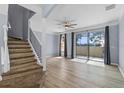 Bright living room featuring wood floors, sliding glass doors, and a ceiling fan at 1236 S Beach Cir, Kissimmee, FL 34746