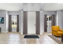 Elegant foyer featuring tile flooring, high ceilings, and bright windows with curtains at 13606 Summer Rain Dr, Orlando, FL 32828