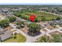 An aerial view shows the home is nestled in a serene neighborhood with mature trees and green spaces at 150 Bentley Oaks Blvd, Davenport, FL 33896