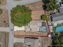 Aerial view of home with pool, fenced yard, and mature trees on a quiet street at 150 Bentley Oaks Blvd, Davenport, FL 33896