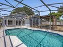 A refreshing pool and screened-in patio offer outdoor enjoyment at 150 Bentley Oaks Blvd, Davenport, FL 33896