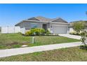 Lovely single Gathering home with manicured landscaping and a long driveway at 236 Aquamarine Ln, Kissimmee, FL 34758