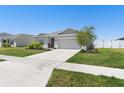 A well-maintained single Gathering home featuring a two car garage and lawn at 236 Aquamarine Ln, Kissimmee, FL 34758