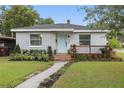 Charming home featuring a well-manicured lawn and inviting front yard with a light-blue front door at 24 W King St, Orlando, FL 32804