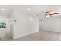 Bright and airy living room featuring neutral tile flooring and modern ceiling fan at 2623 Parsley Dr, Orlando, FL 32837