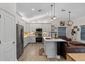 Modern kitchen features stainless steel appliances, white cabinets, and a spacious island at 2651 Sunrise Blvd, Mount Dora, FL 32757