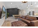 Open-concept living area with a modern kitchen, comfortable seating, and stylish decor at 2651 Sunrise Blvd, Mount Dora, FL 32757