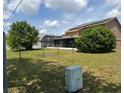 Spacious backyard showcasing a screened-in patio and lush greenery at 301 Blue Bayou Dr, Kissimmee, FL 34743