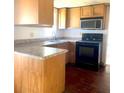 Efficient kitchen featuring modern appliances, stone countertops, and ample cabinet space at 311 E Bridgers Ave, Auburndale, FL 33823