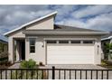 Inviting one-story home with a manicured front yard and a two-car garage, framed by a wrought iron fence at 3289 Songbird Cir, Harmony, FL 34773