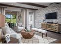 Modern living room showcasing stone accent wall, sliding glass doors, and stylish decor at 3289 Songbird Cir, Harmony, FL 34773