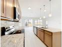 Modern kitchen with island, stainless steel appliances, and an open concept layout at 341 Bahia Cir, Longwood, FL 32750