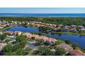 Community aerial showcasing waterfront property, manicured lawns, and community landscaping at 3908 Coastal Breeze Dr, Kissimmee, FL 34744