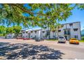 Wide exterior angle of white condo building and parking area on a sunny day at 4117 S Semoran Blvd # 17, Orlando, FL 32822