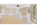 Spacious living room with tile flooring, ceiling fan, and natural light streaming from windows at 420 Summit Ridge Pl # 112, Longwood, FL 32779
