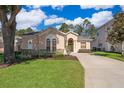 Inviting single-story home with landscaped lawn, charming arched windows, and a well-maintained exterior at 428 Orista Dr, Davenport, FL 33897