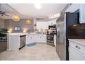Bright kitchen with white cabinets, stainless steel appliances, quartz countertops, and pendant lighting at 428 Orista Dr, Davenport, FL 33897