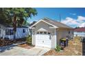 Side view of a well-maintained one car garage attached to the house at 50989 Highway 27 # 174, Davenport, FL 33897