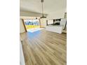 Bright living room featuring stylish vinyl floors, ceiling fan and sliding glass door to the backyard at 658 Caribbean Dr, Davenport, FL 33897
