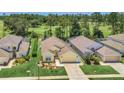 A beautiful aerial view of a single-story home with a golf course community in the background at 715 Troon Cir, Davenport, FL 33897