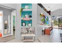 Inviting hallway with decorative niches, stylish decor, and tiled floors with accents at 715 Troon Cir, Davenport, FL 33897