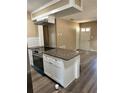 Well-designed kitchen island with cooktop, granite counters, and white cabinets for ample storage space at 804 Little Wekiwa Dr, Altamonte Springs, FL 32714