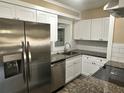 Modern kitchen featuring stainless steel appliances, granite countertops, and white cabinetry at 804 Little Wekiwa Dr, Altamonte Springs, FL 32714