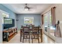 Bright dining room featuring tile floors and doors leading to an outdoor area at 8606 Lsu Ln, Orlando, FL 32817