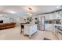 Open-concept kitchen with stainless steel appliances, a granite island, and seamless flow to living area at 8606 Lsu Ln, Orlando, FL 32817