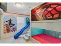 Bedroom featuring custom bunkbeds with a slide and unique Spider-Personal themed decor at 8814 Geneve Ct, Kissimmee, FL 34747