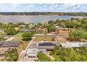 An aerial view showing the property near a picturesque lake, landscaped homes, and mature trees at 932 Campbell Ave, Lake Wales, FL 33853