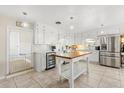Bright kitchen with stainless steel appliances, tile backsplash and floors, and a butcher block island at 932 Campbell Ave, Lake Wales, FL 33853