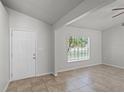 Bright living room with tiled floor, ceiling fan, and a view to the outdoors through a window at 996 Big Oaks Dr, Oviedo, FL 32765