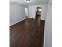 Spacious living room with hard wood floors, neutral colors, and archway leading to kitchen at 1125 W 8Th St, Lakeland, FL 33805