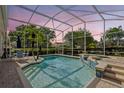 Inviting pool and spa with a screened-in enclosure, providing a private and serene atmosphere at 11401 Willow Stowe Ln, Windermere, FL 34786