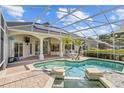 Relaxing screened-in pool area with patio seating and lush landscaping, perfect for outdoor living at 11401 Willow Stowe Ln, Windermere, FL 34786