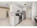 Bright kitchen with ample counter space, white cabinetry, and an open layout to the living area at 1153 Perpignan Ct, Kissimmee, FL 34759