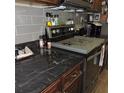 Close-up of modern kitchen showcasing dark granite countertops and stainless steel appliances at 1160 Rolling Acres Dr, Deland, FL 32720