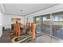 Bright dining area with table, chairs, a decorative rug, and a view of the outdoor pool table at 11734 Lake Willis Dr, Orlando, FL 32821