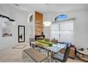 Bright dining room featuring a glass-top table, unique light fixtures, and an elegant decor at 119 Hypolita Ave, Davenport, FL 33897
