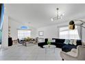 Open living room with tile flooring, comfortable seating, and ample natural light at 119 Hypolita Ave, Davenport, FL 33897
