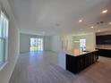 Bright, open-concept living room with tile flooring and sliding glass doors at 1243 Bear Oak Ln, Deland, FL 32720