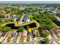 Aerial view of home nestled in a lush community with ponds and mature trees at 12817 Parkbury Dr, Orlando, FL 32828